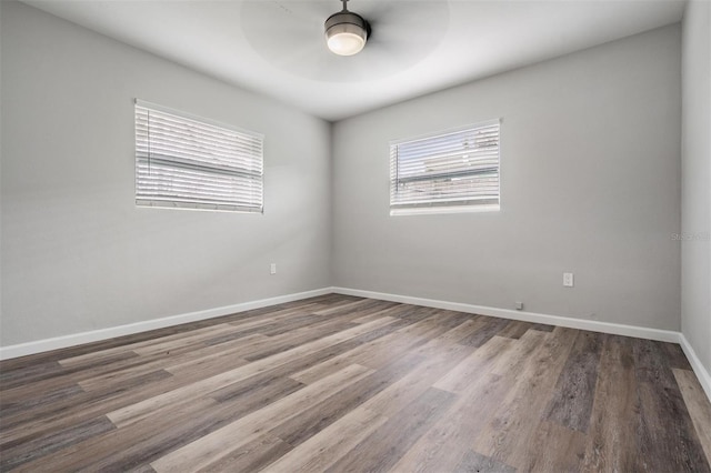 empty room with ceiling fan and hardwood / wood-style flooring