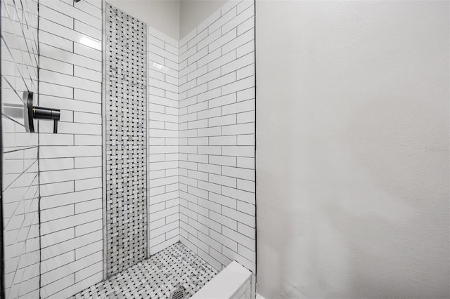 bathroom with tiled shower