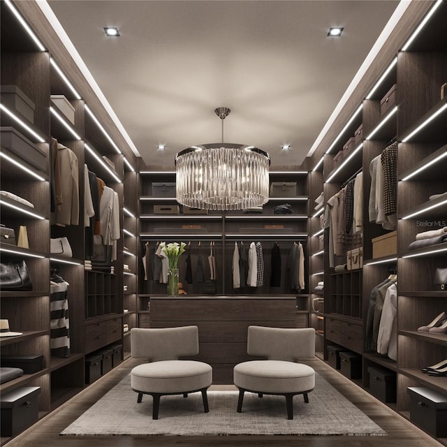 spacious closet featuring a notable chandelier