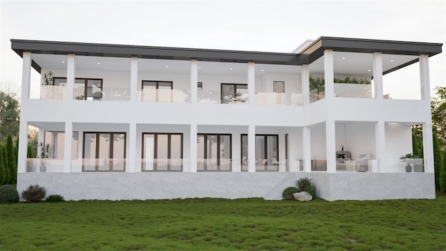 rear view of property with a balcony and a lawn