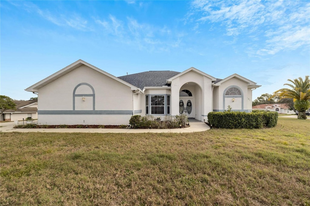 single story home with a front lawn and a garage