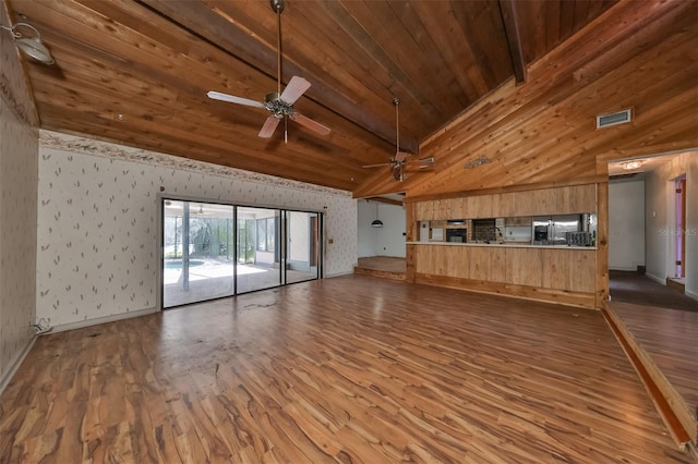 unfurnished living room with high vaulted ceiling, dark hardwood / wood-style flooring, wooden ceiling, and ceiling fan