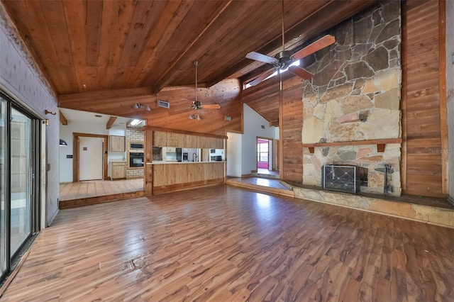 unfurnished living room with ceiling fan, beamed ceiling, wood ceiling, and hardwood / wood-style floors