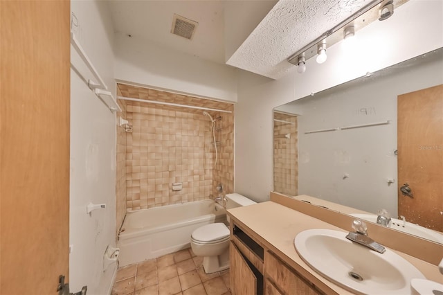 full bathroom featuring tile floors, toilet, vanity, and tiled shower / bath