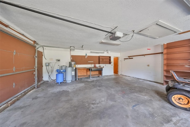 garage featuring water heater and a garage door opener