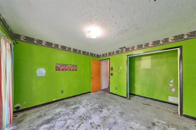 spare room featuring a textured ceiling