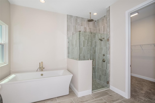 bathroom featuring shower with separate bathtub and plenty of natural light