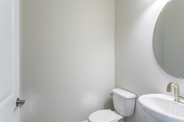 bathroom with toilet and sink