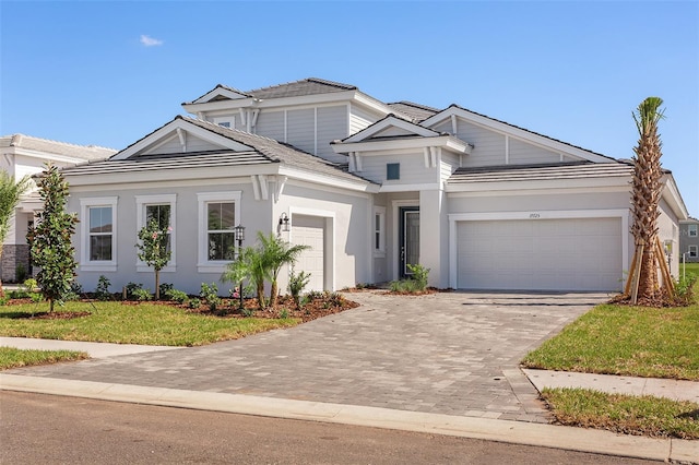 view of front facade with a garage and a front lawn