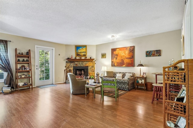 living room with a textured ceiling and hardwood / wood-style flooring