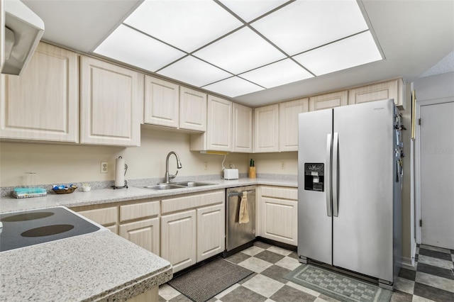 kitchen with dark tile flooring, sink, and stainless steel appliances