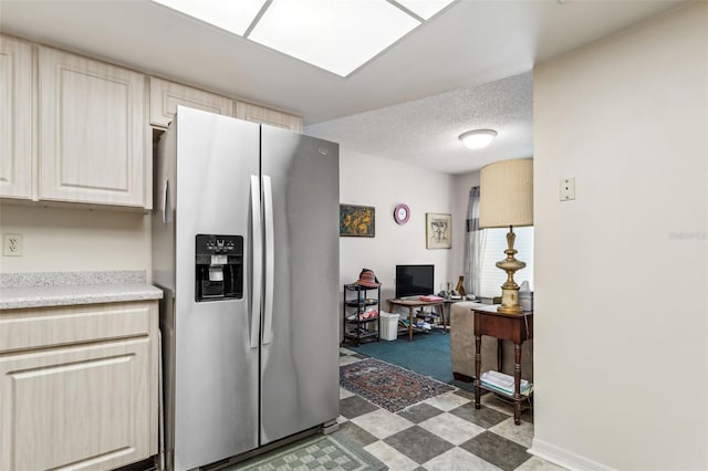 kitchen with stainless steel fridge with ice dispenser, tile flooring, and light brown cabinets