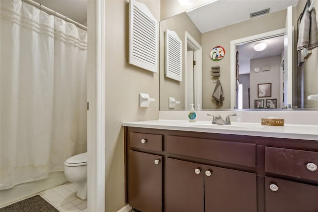 bathroom with toilet, a textured ceiling, vanity, and tile flooring