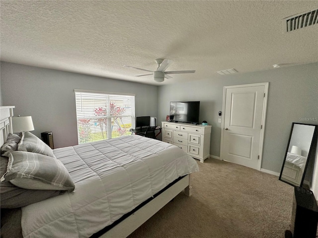 bedroom featuring baseboards, a ceiling fan, visible vents, and light carpet