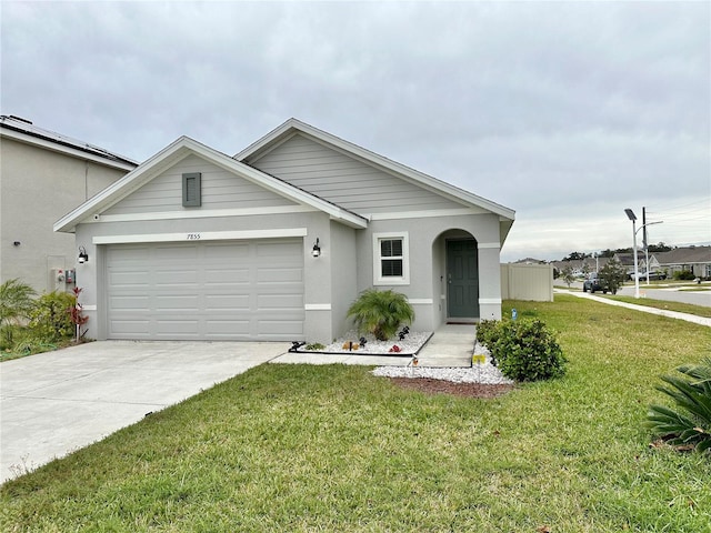 view of front of home with a garage, concrete driveway, a front yard, and stucco siding