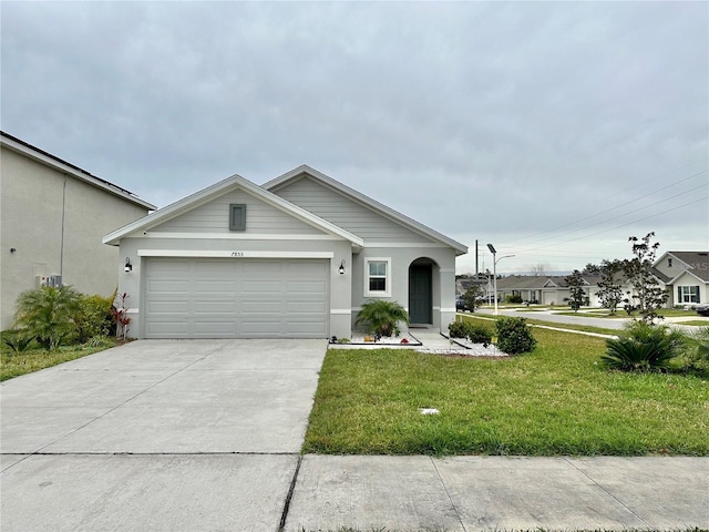 view of front of home with a front yard, a garage, driveway, and stucco siding