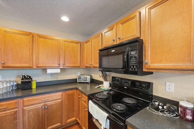 kitchen featuring a textured ceiling and black appliances