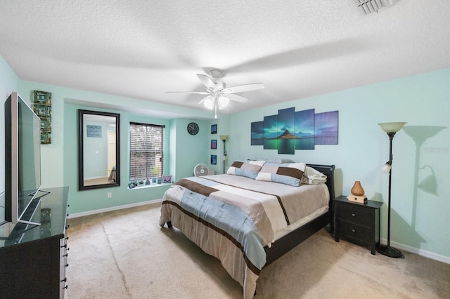 carpeted bedroom with a textured ceiling and ceiling fan