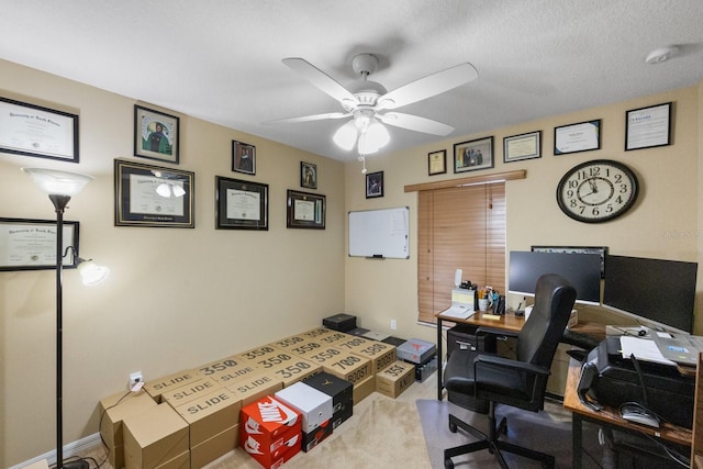 office space featuring a textured ceiling, ceiling fan, and carpet