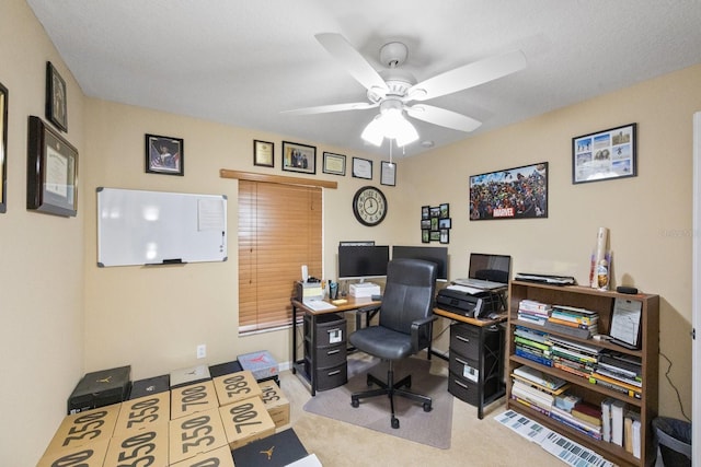 office space featuring light carpet and ceiling fan