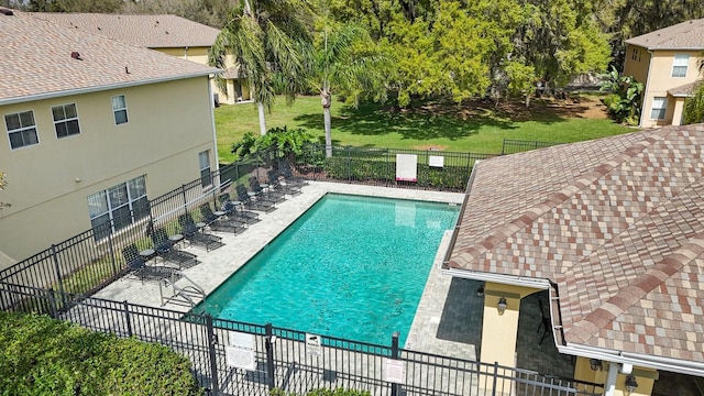 view of pool featuring a lawn