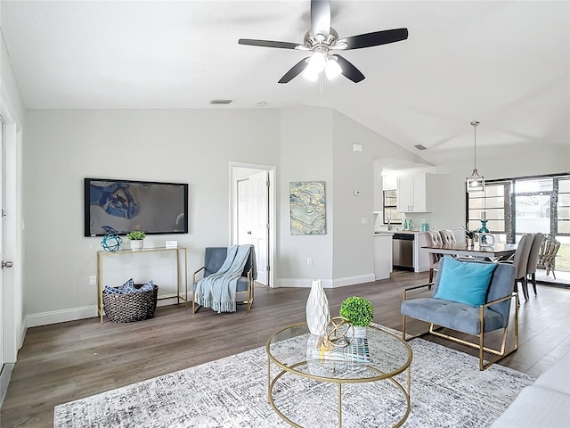 living room featuring lofted ceiling, ceiling fan, and light wood-type flooring