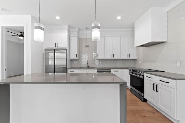 kitchen with decorative light fixtures, ceiling fan, white cabinetry, and appliances with stainless steel finishes