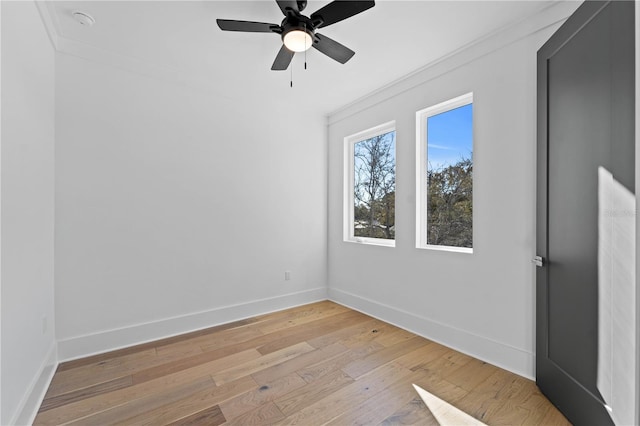 empty room with ceiling fan, light hardwood / wood-style flooring, and ornamental molding