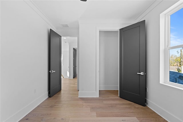 unfurnished bedroom featuring light hardwood / wood-style flooring and ornamental molding