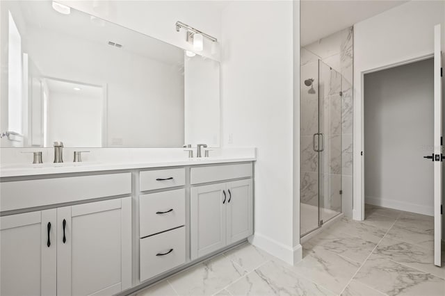 bathroom featuring a shower with door and vanity