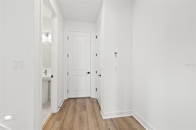 hallway with light wood-type flooring