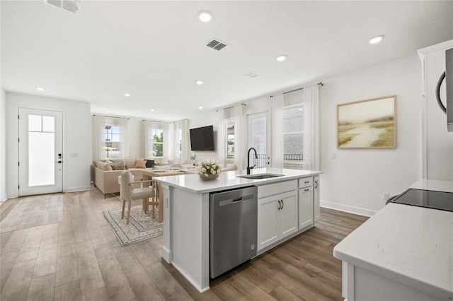 kitchen featuring dishwasher, white cabinets, dark wood-type flooring, and a kitchen island with sink