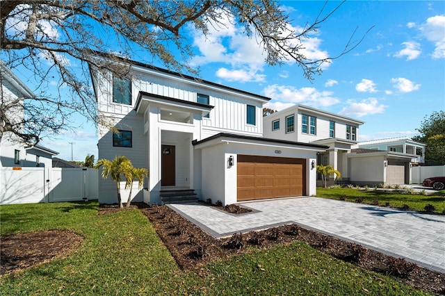 view of front of home with a garage and a front yard