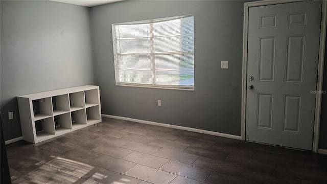 empty room with dark tile patterned floors