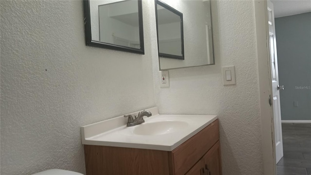 bathroom with vanity and wood-type flooring