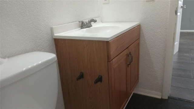 bathroom with toilet and vanity