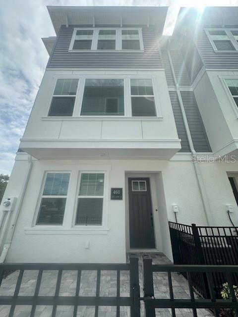 view of front of house with a fenced front yard and stucco siding