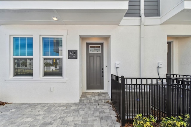 entrance to property with stucco siding