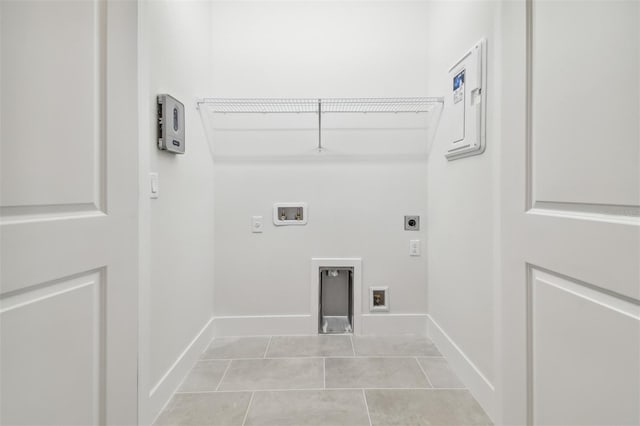 laundry room with electric dryer hookup, washer hookup, and light tile patterned floors