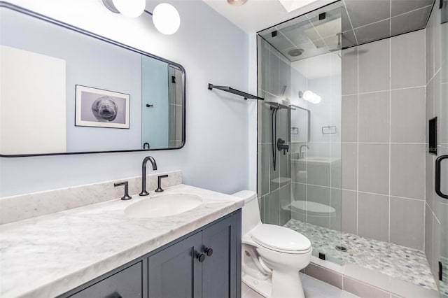 bathroom with toilet, an enclosed shower, and vanity