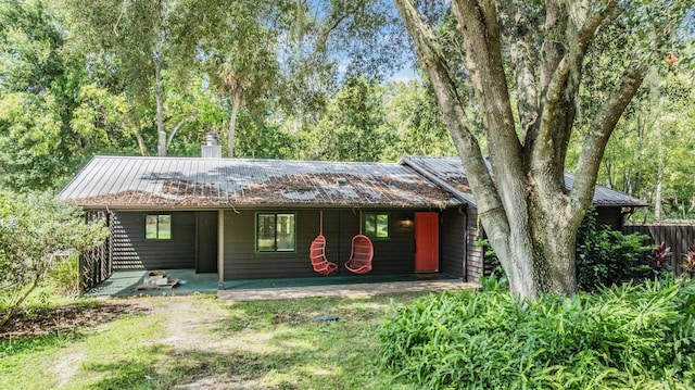 8952 W White Dogwood Dr, Homosassa, FL 34448 - view of front of home featuring metal roof, covered porch, and a chimney