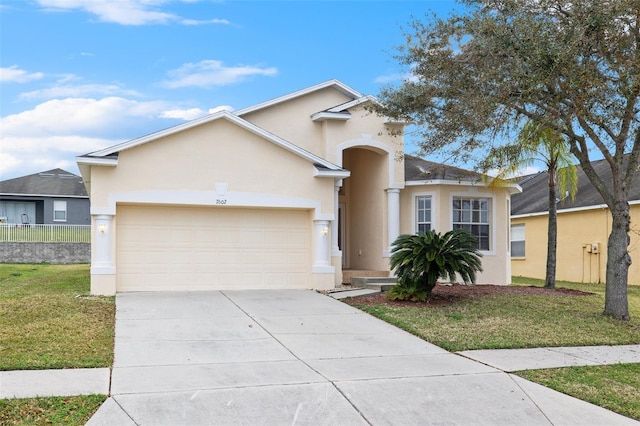 view of front of house with a front yard and a garage