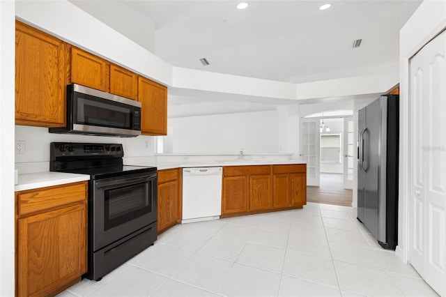 kitchen featuring light tile flooring, appliances with stainless steel finishes, and sink