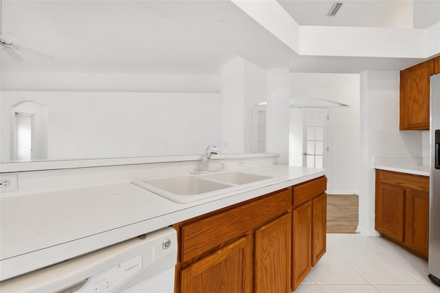 kitchen with light tile floors, ceiling fan, dishwasher, and sink