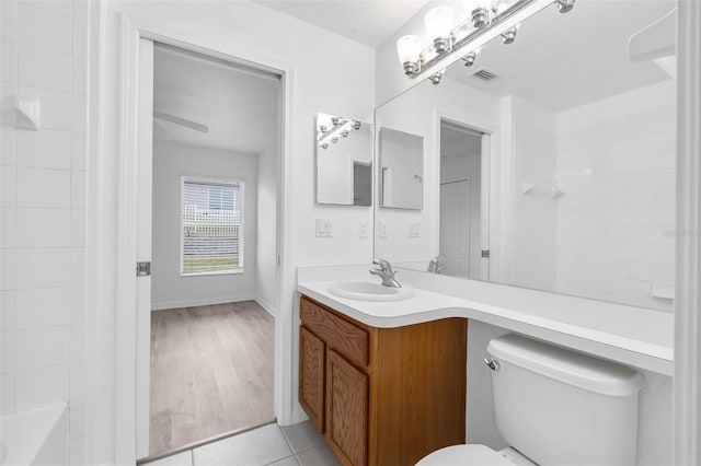 full bathroom with  shower combination, hardwood / wood-style floors, toilet, and vanity