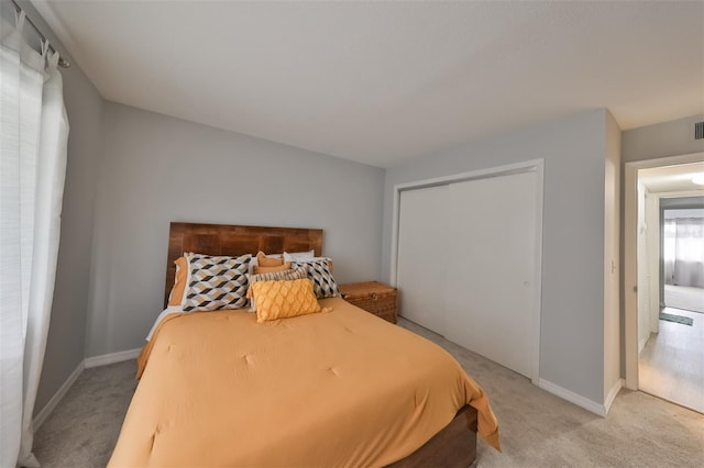 carpeted bedroom with a closet