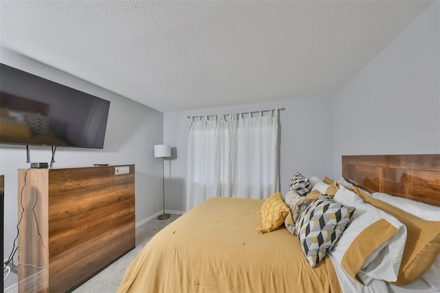 bedroom featuring a textured ceiling and carpet floors