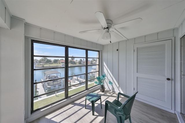 interior space featuring a water view, ceiling fan, and a wealth of natural light