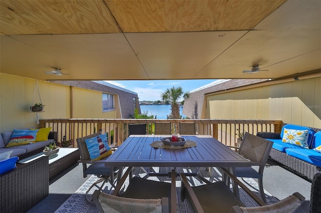 view of terrace with a water view and outdoor lounge area