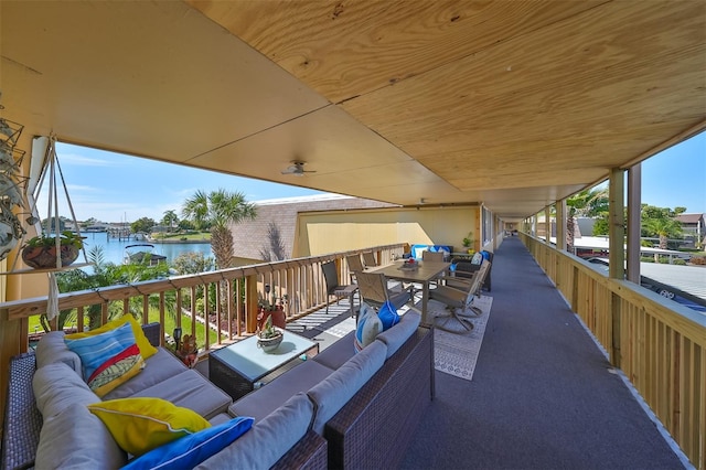 balcony featuring an outdoor hangout area and a water view